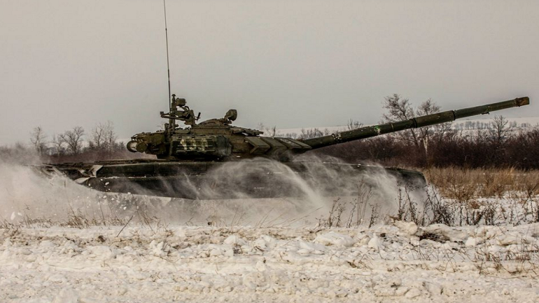 A tank of Russian armed forces drives during military exercises in the Leningrad Region, Russia, in this handout picture released February 14, 2022.