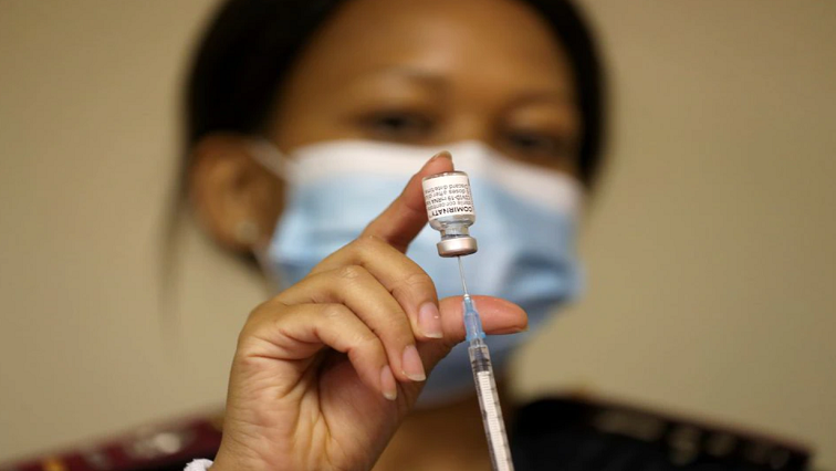 A health worker holds a vial of the coronavirus disease (COVID-19) vaccine.