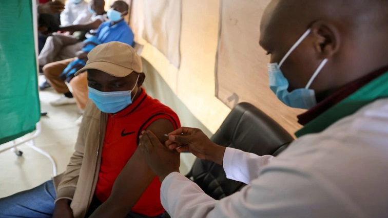 A healthcare professional administers a dose of AstraZeneca (COVID-19) vaccine at the Narok County Referral Hospital, in Narok, Kenya, December 1, 2021.