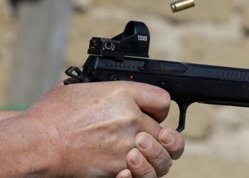 A man shoots a CZ 9x21 caliber pistol.