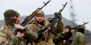 Militants of the self-proclaimed Donetsk People's Republic take part in shooting drills at a range on the outskirts of Donetsk, Ukraine, December 14, 2021.