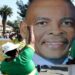 A supporter gestures in front of a picture of Ace Magashule ahead of his court appearance at the Bloemfontein High Court on November 13, 2020.