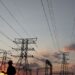 File image: A man walks past electricity pylons in Soweto, South Africa,