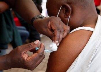 A civilian receives the coronavirus disease (COVID-19) vaccine at a makeshift tent as the government orders for proof of vaccination to access public places and transport, in downtown Nairobi, Kenya December 23, 2021.