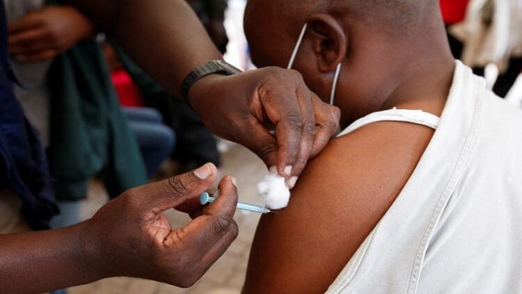 A civilian receives the coronavirus disease (COVID-19) vaccine at a makeshift tent as the government orders for proof of vaccination to access public places and transport, in downtown Nairobi, Kenya December 23, 2021.