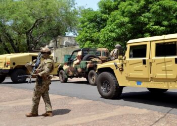 File image: Malian army members stand guard..