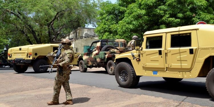 File image: Malian army members stand guard..