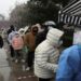 People line up amid snowfall at a mobile nucleic acid testing site, following the coronavirus disease (COVID-19) outbreak, in Beijing, China March 18, 2022. 