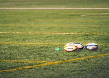 [File photo] Rugby balls on a field.