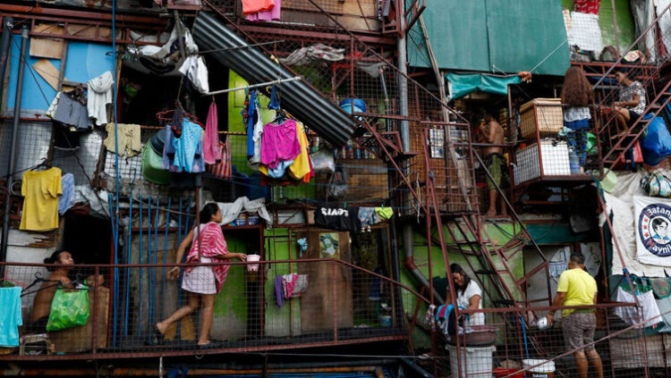 Residents of a small apartment building do house chores outside their units, amid the lockdown to contain the coronavirus disease (COVID-19), in a slum area in Tondo, Manila, Philippines, May 4, 2020.