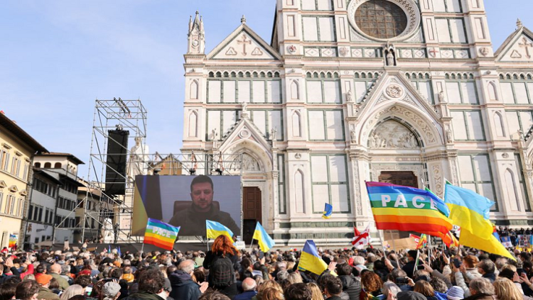 Ukrainian President Volodymyr Zelenskyy addresses demonstrators via video as they gather in Santa Croce square to protest against the Russian invasion of Ukraine.