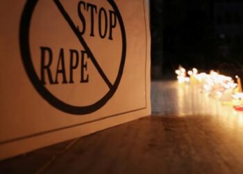 File image: A poster is seen at a candle-lit march to remember rape and murder victims.