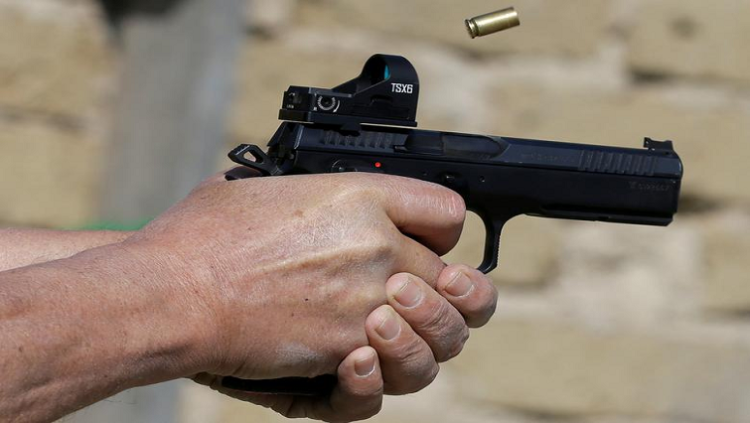 [File Image] A man fires a shot from a handgun.