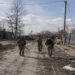Ukranian servicemen walk through the village of Lukyanivka outside Kyiv, as Russia's invasion of Ukraine continues,  March 27, 2022.