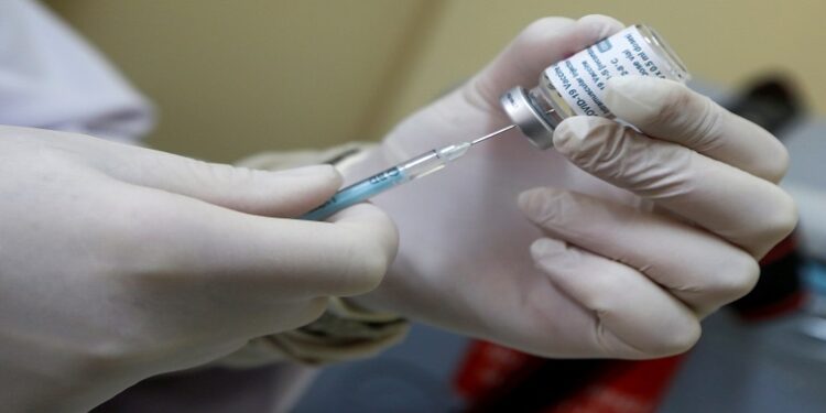 Health worker administering vaccine.