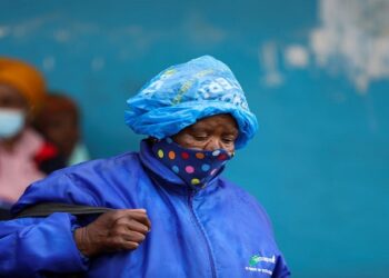 A woman wearing a protective face mask against the coronavirus disease looks on at Tsomo in the Eastern Cape, December 2, 2021. 
