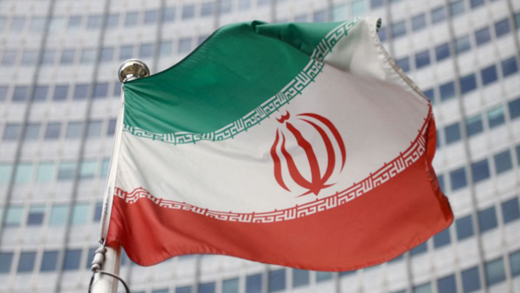 The Iranian flag waves in front of the International Atomic Energy Agency (IAEA) headquarters in Vienna, Austria, March 1, 2021. REUTERS/Lisi Niesner/File Photo