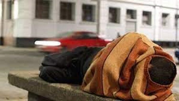 [File photo] Homeless person sleeping on a bench.