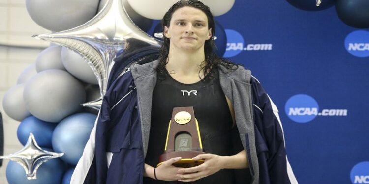 Penn Quakers swimmer Lia Thomas holds a trophy after finishing first in the 500 free at the NCAA Womens Swimming & Diving Championships at Georgia.