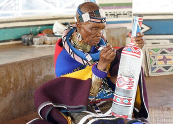 World renowned and award-winning Ndebele artist, Esther Mahlangu (87) working on a collaborative bottle for an alcohol brand.
