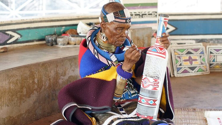 World renowned and award-winning Ndebele artist, Esther Mahlangu (87) working on a collaborative bottle for an alcohol brand.