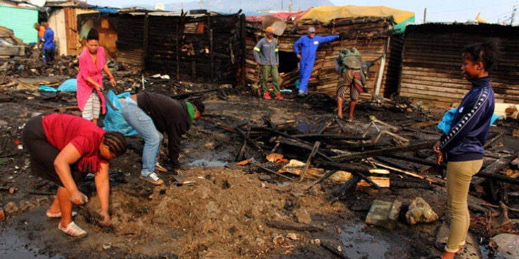 Residents salvage what they can after 50 homes were burned down in a fire which ripped through Joe Slovo informal settlement.