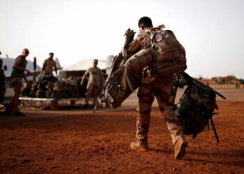 A French soldier leaves with his backpack at the Operational Desert Platform Camp (PfOD) during the Operation Barkhane in Gao, Mali.