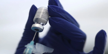 A healthcare worker prepares a Pfizer coronavirus disease (COVID-19) vaccination.