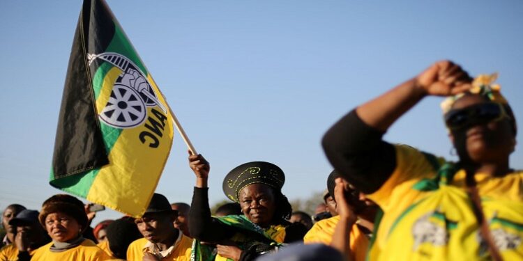 Supporter of the African National Congress holds the party's flag.