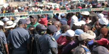 Police officers monitoring Diepsloot residents during a protest.