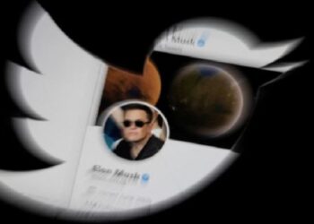 Elon Musk's twitter account is seen through the Twitter logo in this illustration taken, April 25, 2022.