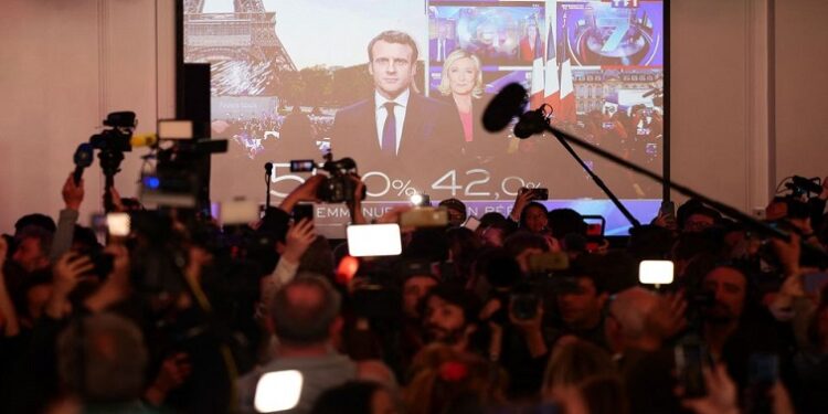 Supporters of Marine Le Pen, French far-right National Rally (Rassemblement National) party candidate for the 2022 French presidential election, react as early results are projected on a giant screen in the second round vote of the 2022 French presidential election, in Paris, France April 24, 2022.