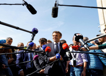 French President Emmanuel Macron, candidate for his re-election in the 2022 French presidential election, talks to journalists during a visit in Saint-Denis as he campaigns in Seine-Saint-Denis ahead of the second round of the presidential election, France, April 21, 2022. REUTERS/Gonzalo Fuentes