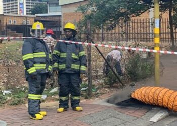 File Photo :Johannesburg emergency services firefighters standing next to a manhole.