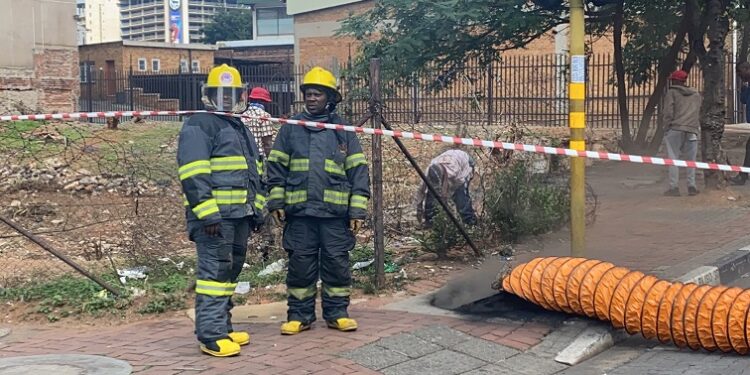 File Photo :Johannesburg emergency services firefighters standing next to a manhole.