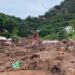 A woman is seen around destroyed buildings after the floods in KwaZulu-Natal.