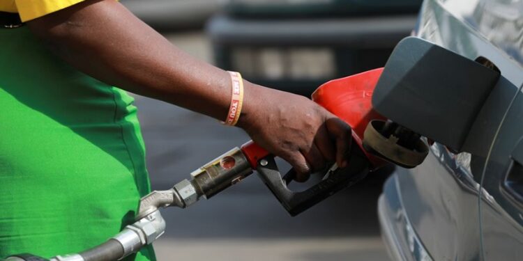 [File image] A petrol attendant pouring fuel in a car.