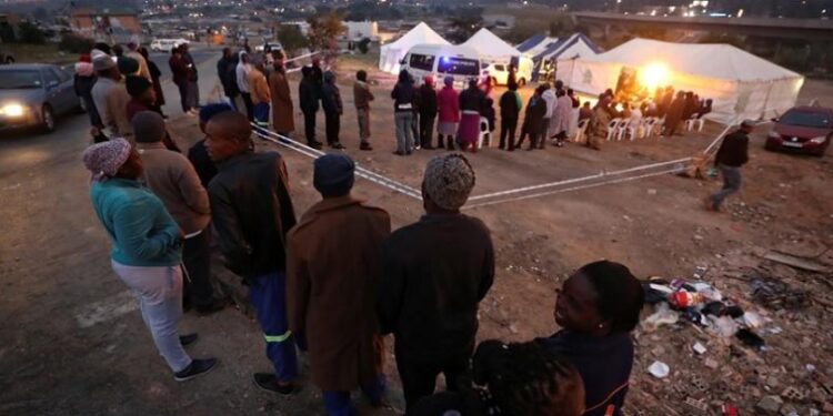Voters queue to cast their ballots in elections, in Alexandra township, Johannesburg.