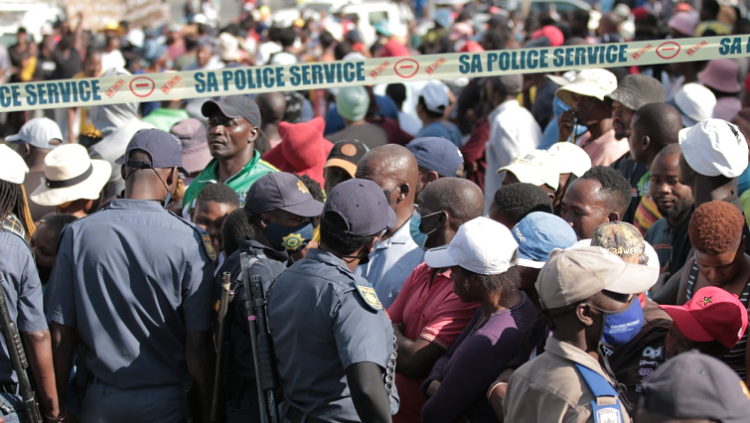 [FILE PHOTO] SAPS members form a human chain to restrict residents during a protest.