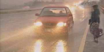 FILE image: A vehicle drives through heavy rain.