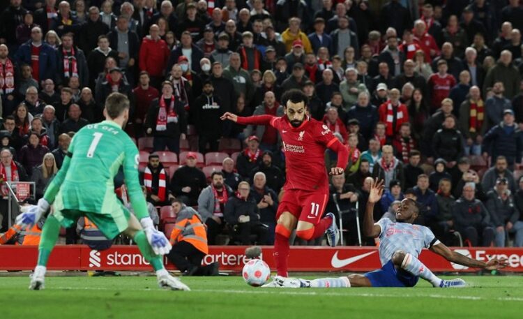 Liverpool v Manchester United - Anfield, Liverpool, Britain - April 19, 2022 Liverpool's Mohamed Salah in action with Manchester United's David de Gea