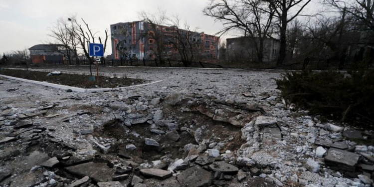 A shell crater is seen in the street during Ukraine-Russia conflict in the besieged southern port of Mariupol, Ukraine March 27, 2022.