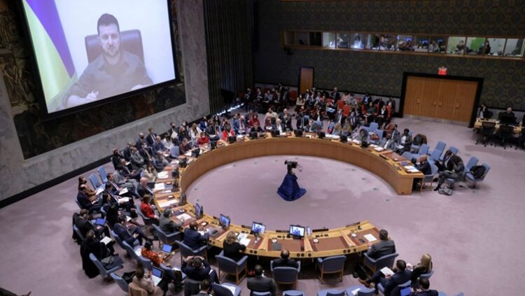 Ukrainian President Volodymyr Zelenskyy  appears on a screen as he addresses the United Nations Security Council via video link during a meeting, amid Russia's invasion of Ukraine, at the United Nations Headquarters in Manhattan, New York City, New York, U.S., April 5, 2022.