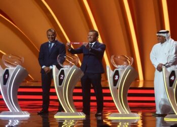 World Cup - Final Draw - Doha Exhibition & Convention Center, Doha, Qatar - April 1, 2022 Draw assistant Lothar Matthaus draws Germany as Cafu and Adel Ahmed MalAllah look on.