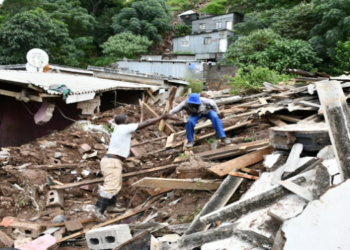 Two men assess the damage to houses following heavy rains in KwaZulu-Natal.