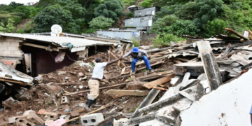 Two men assess the damage to houses following heavy rains in KwaZulu-Natal.