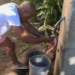 A resident fills his bucket with water from a communal tap