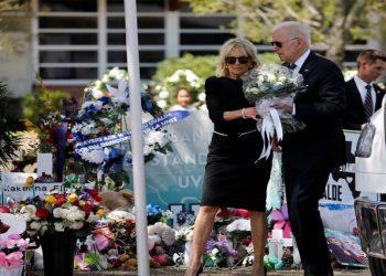 U.S. President Joe Biden and first lady Jill Biden hold a bouquet of 21 white flowers to be laid at the Robb Elementary School memorial, where a gunman killed 19 children and two teachers in the deadliest U.S. school shooting in nearly a decade, as they visit the school, in Uvalde, Texas, U.S. May 29, 2022.