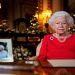 Britain's Queen Elizabeth records her annual Christmas broadcast in the White Drawing Room in Windsor Castle, next to a photograph of the queen and the Duke of Edinburgh, in Windsor, Britain, December 23, 2021.