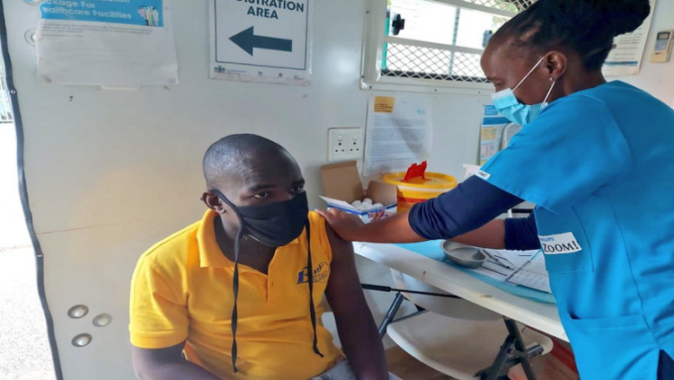A soccer fan gets vaccinated ahead of the match between Mamelodi Sundown and CapeTown City FC at Loftus Versfeld Stadium in Pretoria on April 27, 2022.